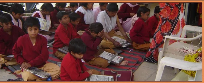 A student receives an XO laptop at the Kikarwali launch