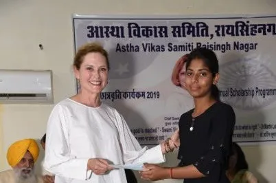 Guest of honor Amy Hawkins hands a scholarship to a student in 2019