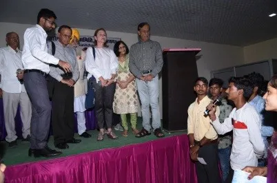 Volunteers and partners on stage